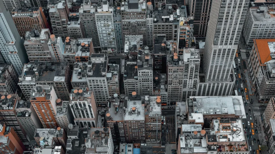 High-angle aerial view of New York City's dense urban skyscrapers and architecture.