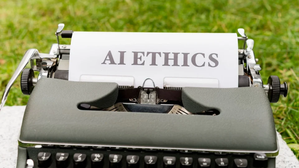 A vintage typewriter outdoors displaying "AI ethics" on paper, symbolizing tradition meets technology.