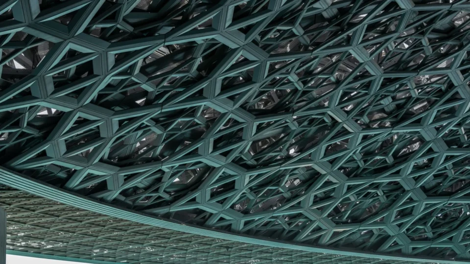 Intricate modern ceiling design at the iconic Louvre Abu Dhabi museum.