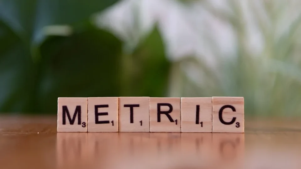 A wooden block spelling the word metallic on a table