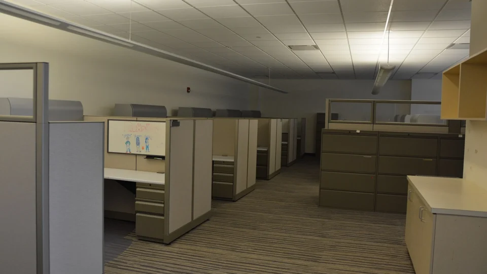 Empty open-plan office with vacant desks and chairs
