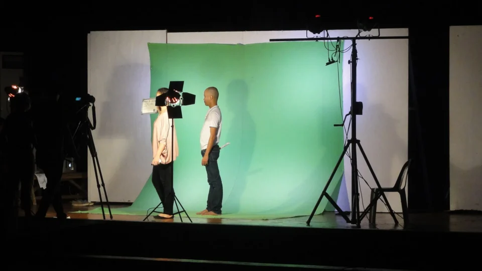 A green-screen chroma-key video studio setup