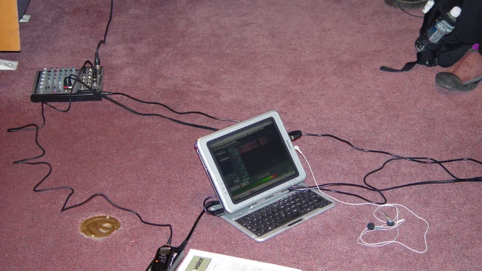 Podcast microphone and headphones on a recording desk