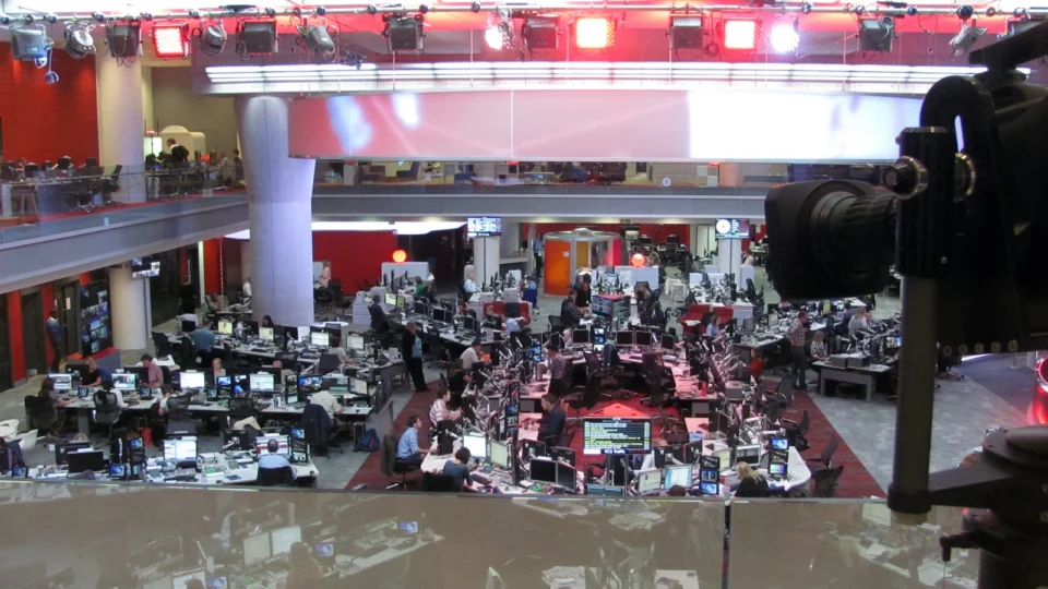 Television newsroom with cameras and journalists' desks