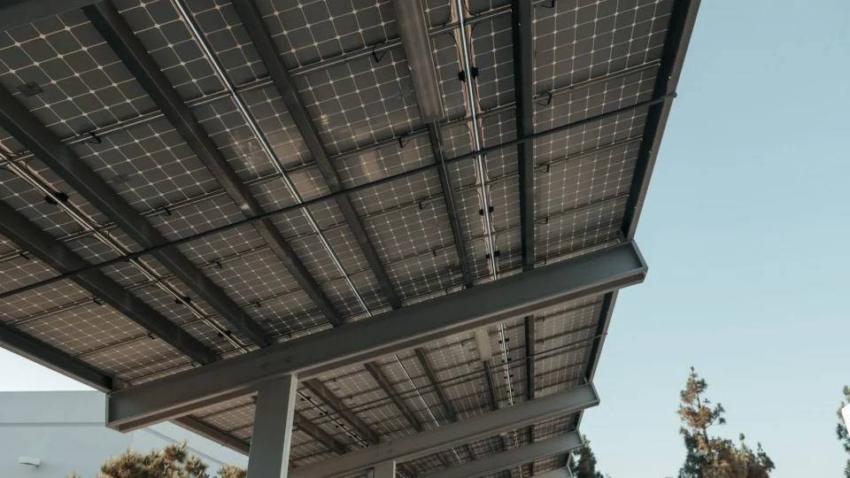 Low-angle view of solar panels under a clear sky, highlighting clean energy.