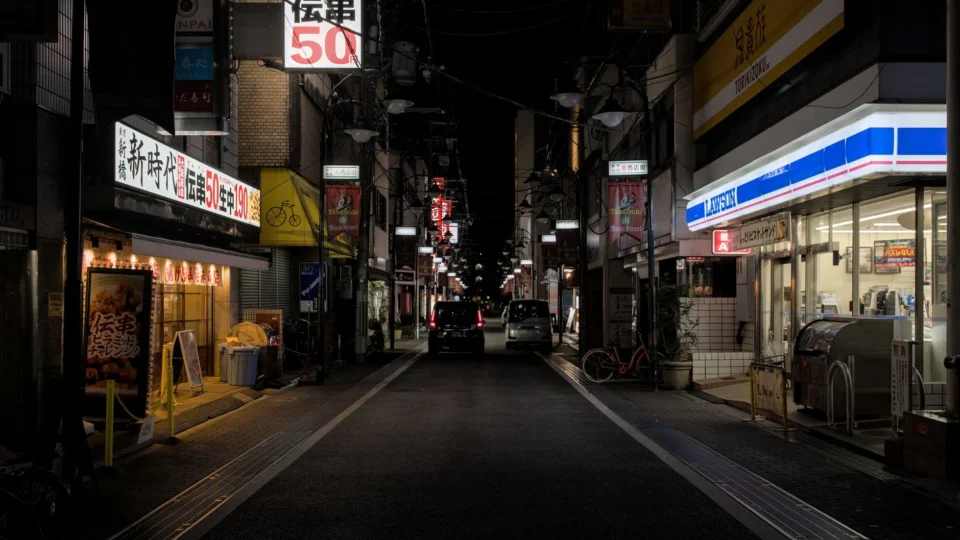 Explore the lively nightlife of Takatsuki, Japan in this urban scene featuring stores and vibrant lights.
