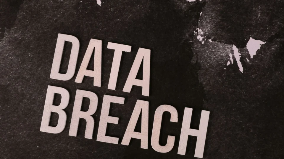 A conceptual image highlighting the issue of data breaches, featuring bold text on a textured background.