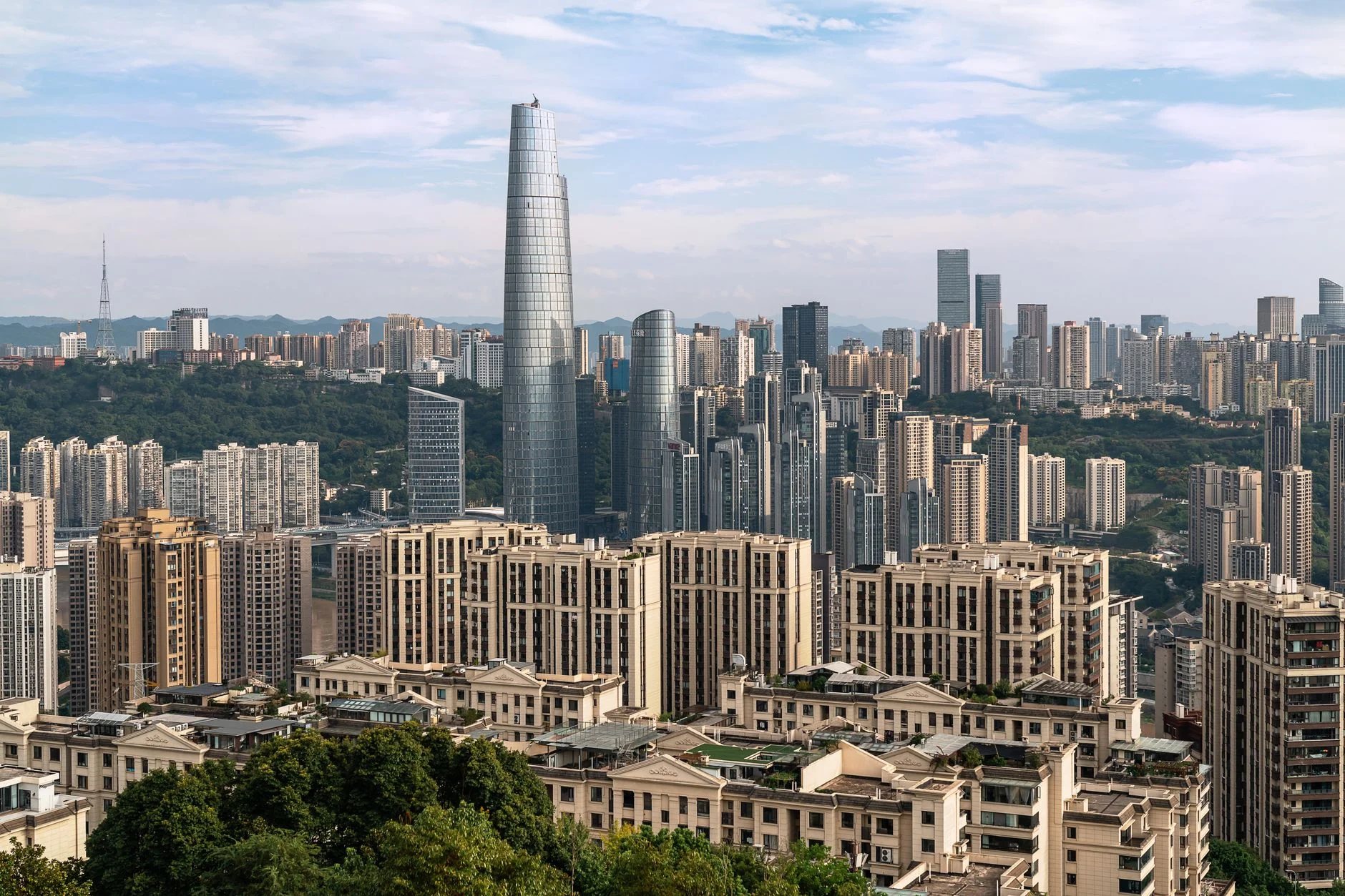 A dynamic cityscape showcasing tall skyscrapers under a clear sky, highlighting urban architecture.
