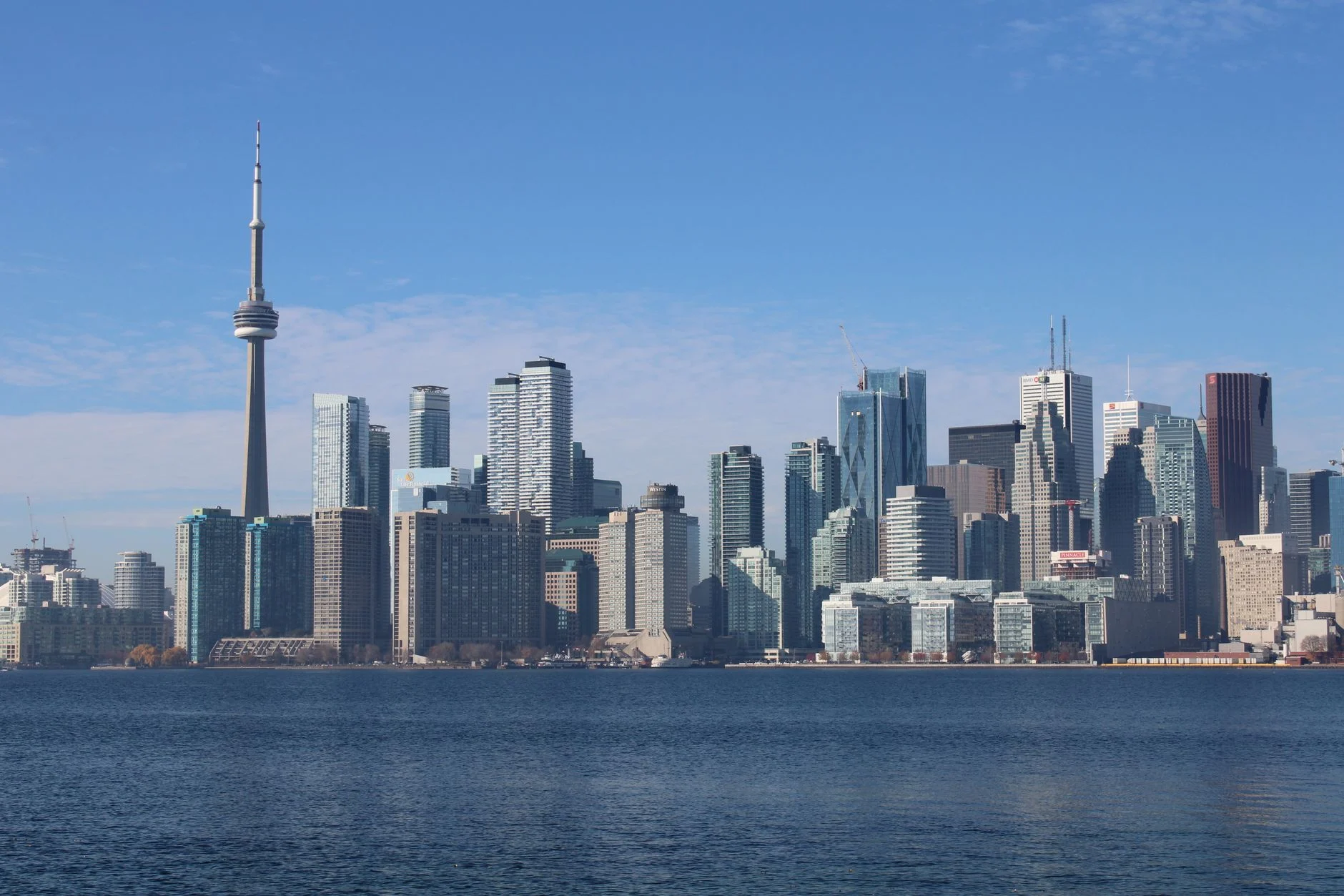 Capture of Toronto's bustling skyline with the iconic CN Tower on a clear day.