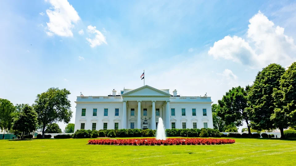 The iconic White House lawn and fountain on a bright summer day in Washington, DC.