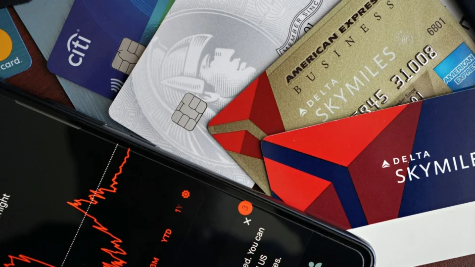Image showing credit cards and a financial market graph on a smartphone.