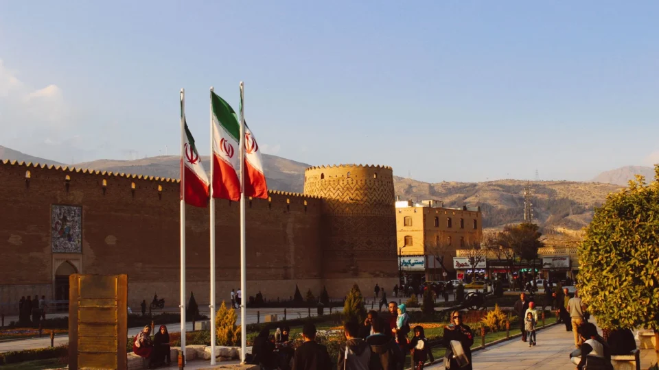 Karim Khan Citadel with Iranian flags in Shiraz, Iran at sunset.