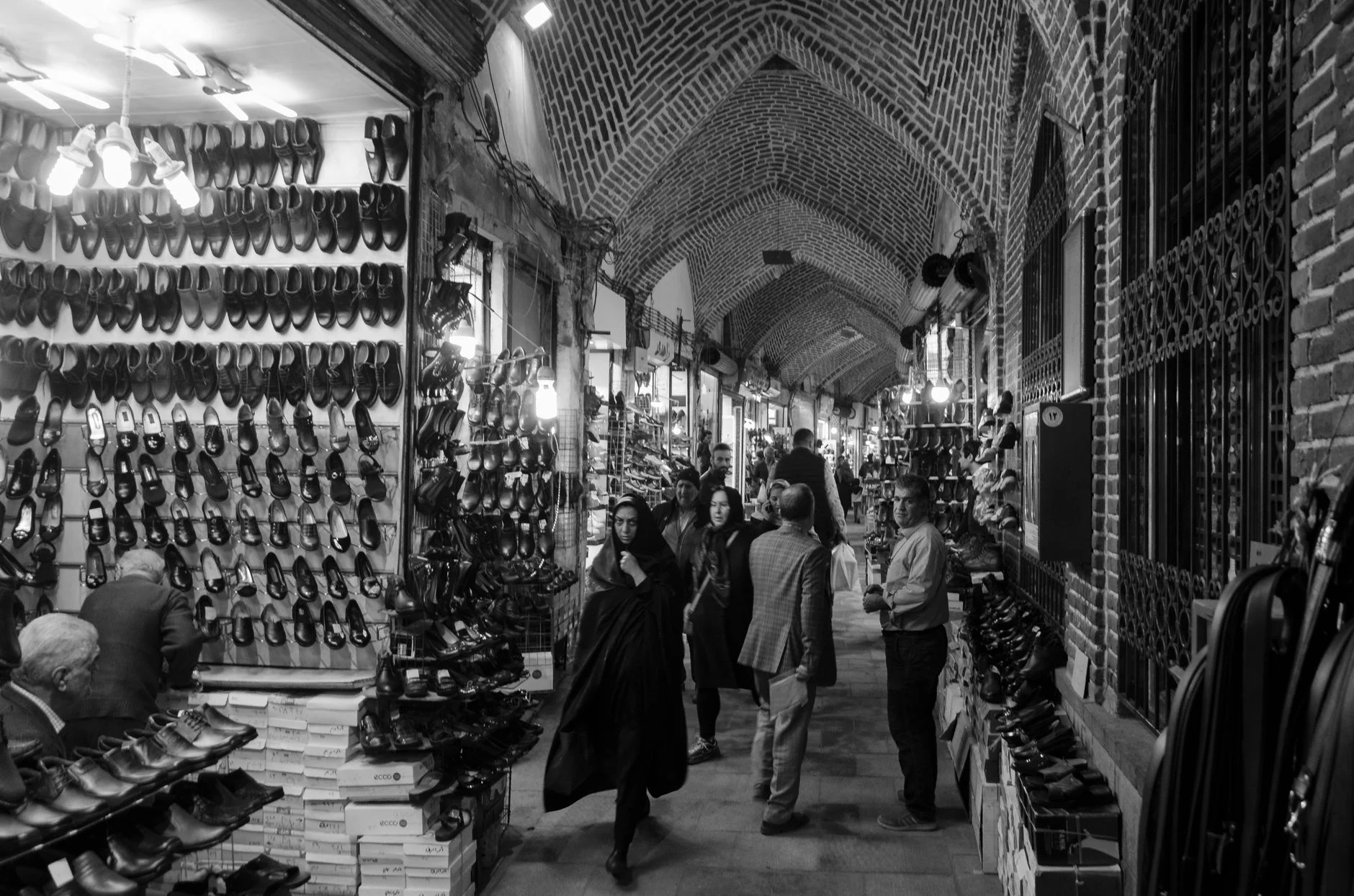 Black and white photo capturing lively market in Tabriz, Iran.