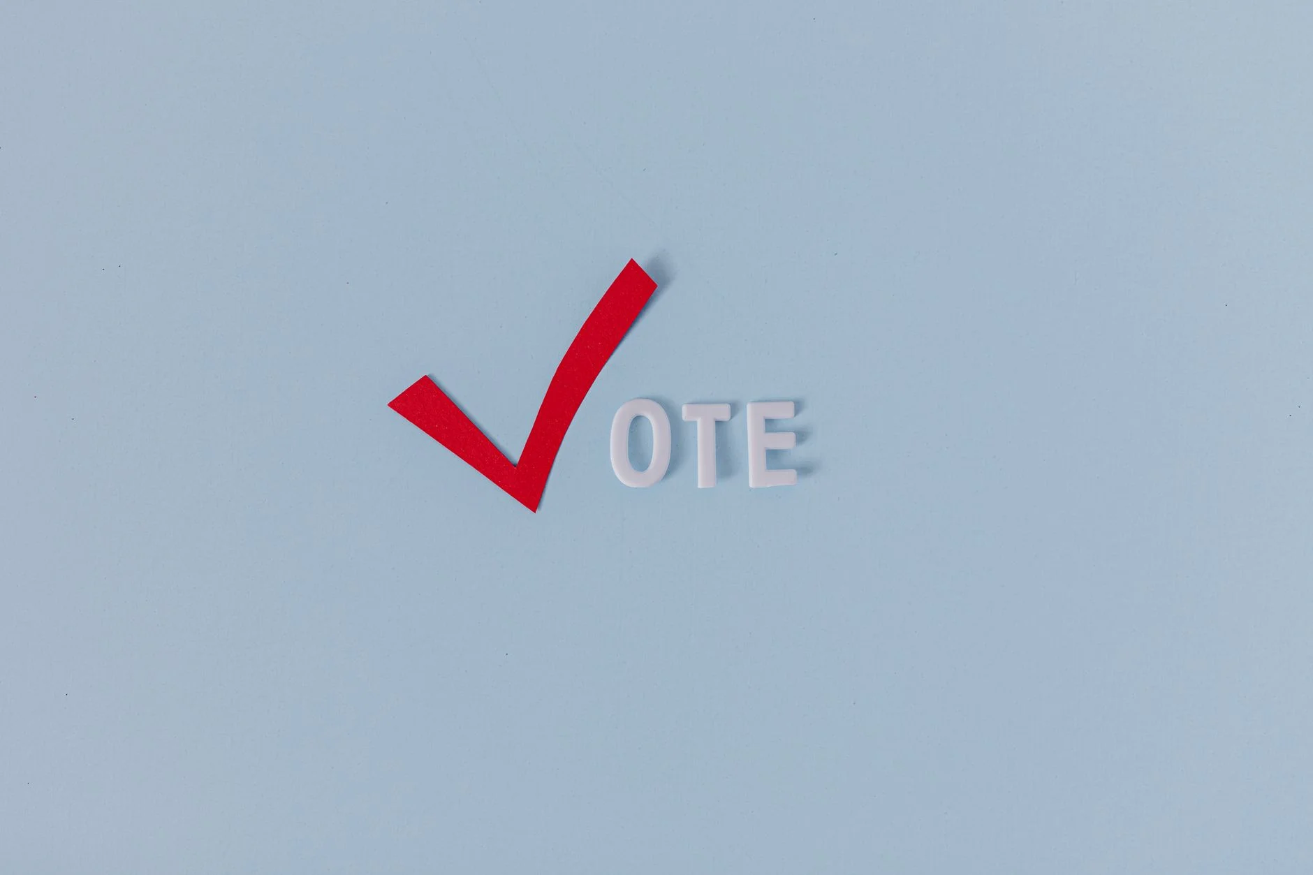 Red check mark with the word "VOTE" on a blue background, symbolizing election participation.