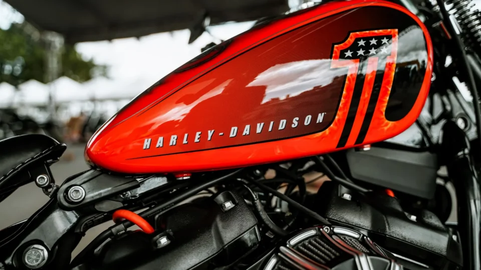 Close-up of a vibrant red Harley-Davidson motorcycle tank. Perfect for automotive enthusiasts.
