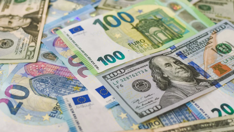 A detailed image of Euro and US dollar banknotes scattered, symbolizing global currency exchange.