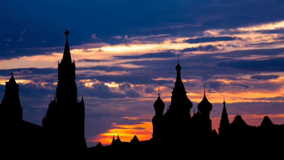 Stunning silhouette of the Kremlin towers against a vibrant sunset sky in Moscow, Russia.
