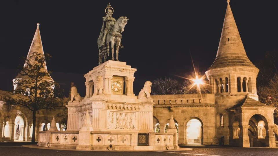 The stunning Fisherman's Bastion in Budapest illuminated at night, showcasing its iconic towers and statues.