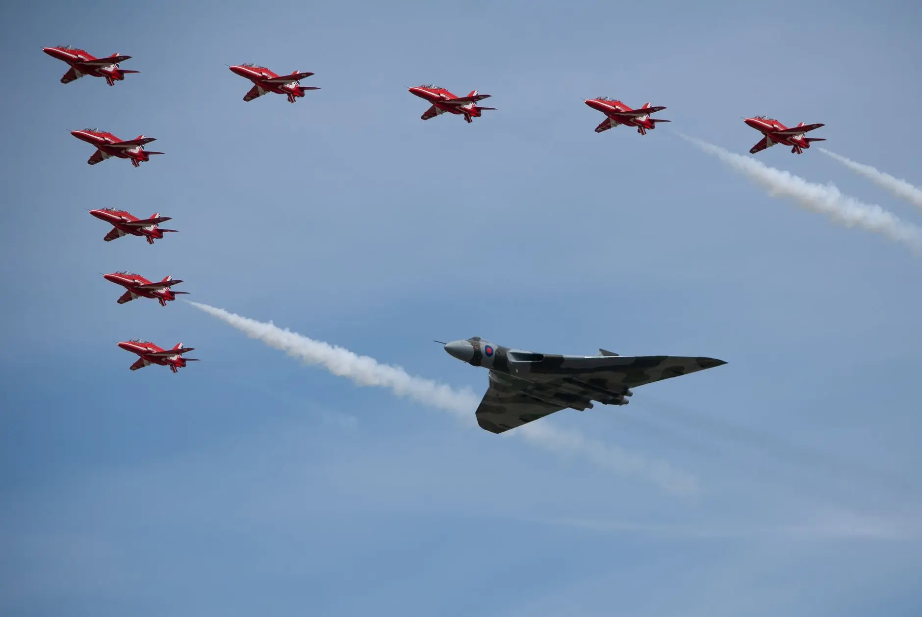 Impressive aerial display featuring the Red Arrows and a Vulcan bomber at the Fairford airshow.