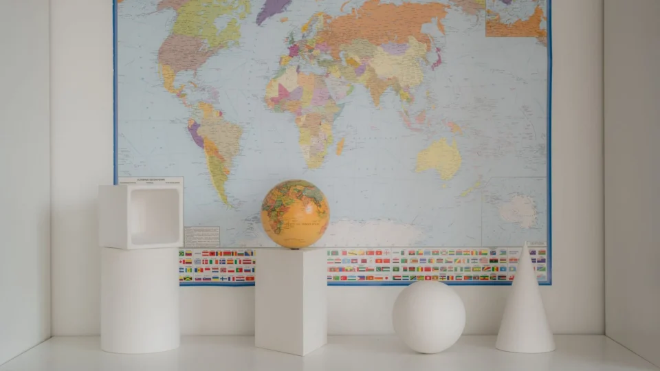Contemporary geometric decor set against a detailed world map backdrop.