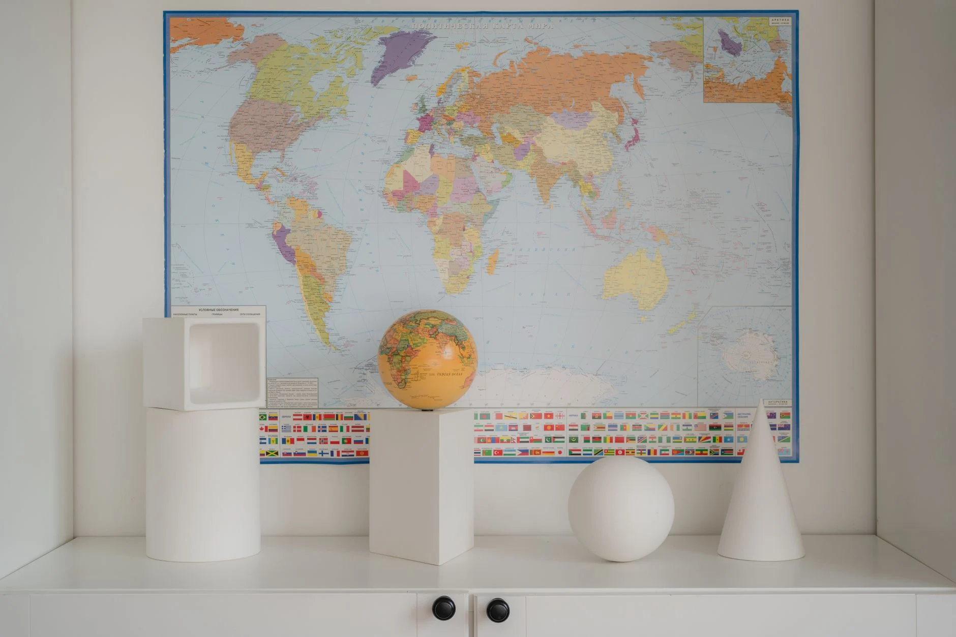 Contemporary geometric decor set against a detailed world map backdrop.