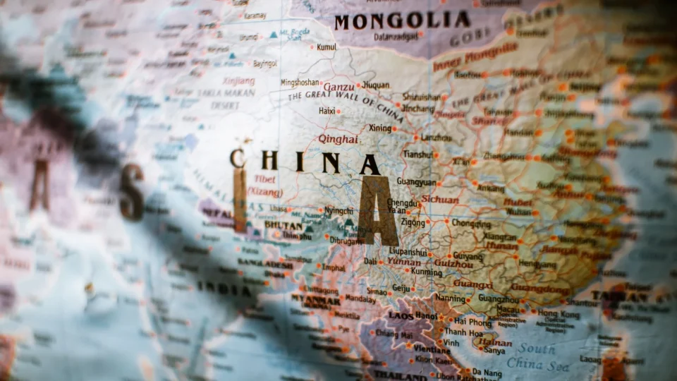 Paper political world map with Asian countries borders and coastline near water