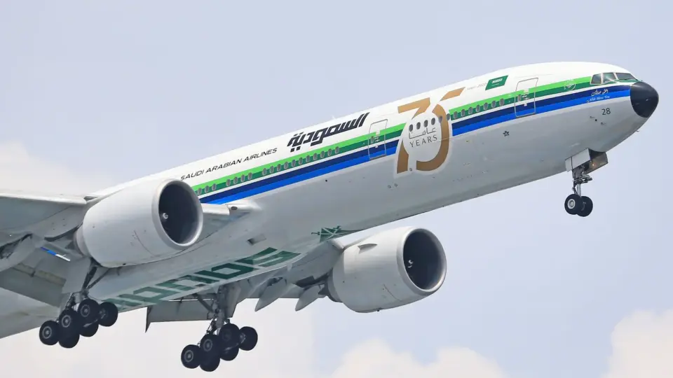 Saudi Arabian Airlines Boeing 777 taking off, marking 75 years of operation.