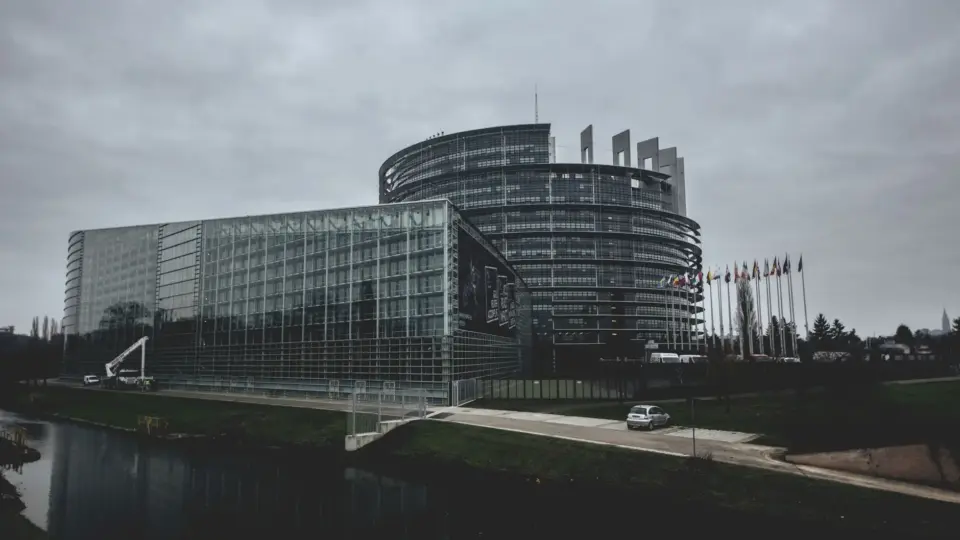 Modern architecture of the European Parliament in Strasbourg on a cloudy day.