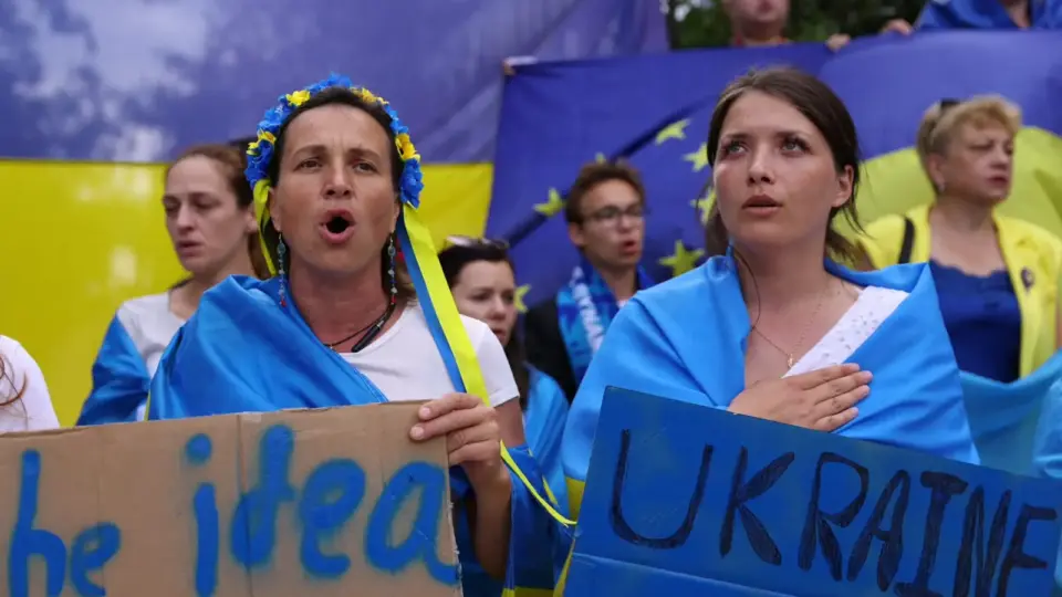 Ukrainian demonstrators holding national and European flags
